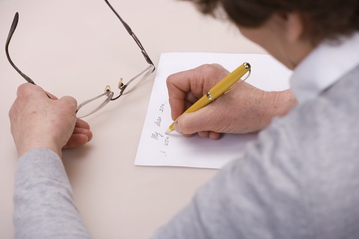 person writing a letter