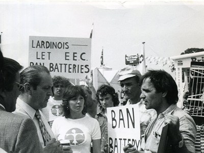 Peter campaigning for farmed animal welfare. He is surrounded by people with some holding signs including 'ban batteries'.