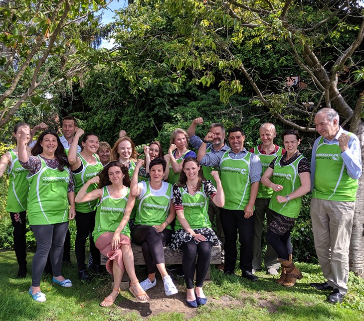 Compassion staff group outside wearing running vests