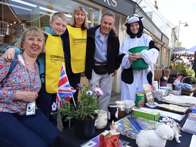 group of volunteers at a stand outside