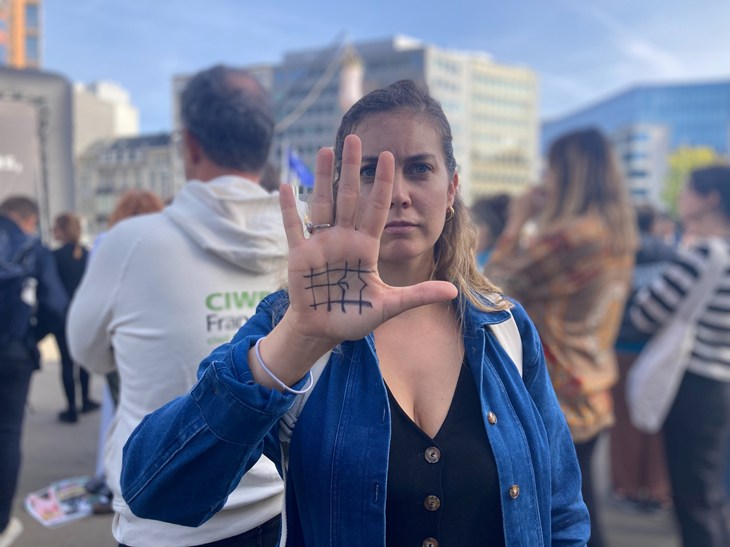 Hand gesture with end the cage age logo