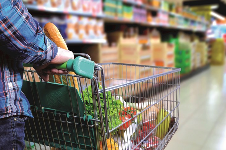 Supermarket trolley in supermarket aisle
